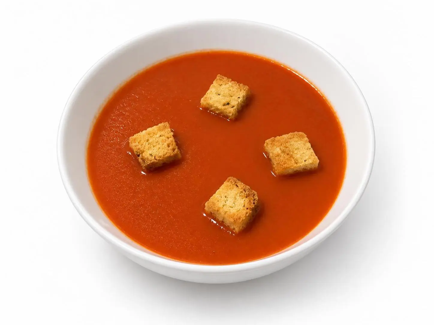 AI-made sample tomato soup with four croutons as a clean packshot menu hero; generated demonstration, not a real customer dish.